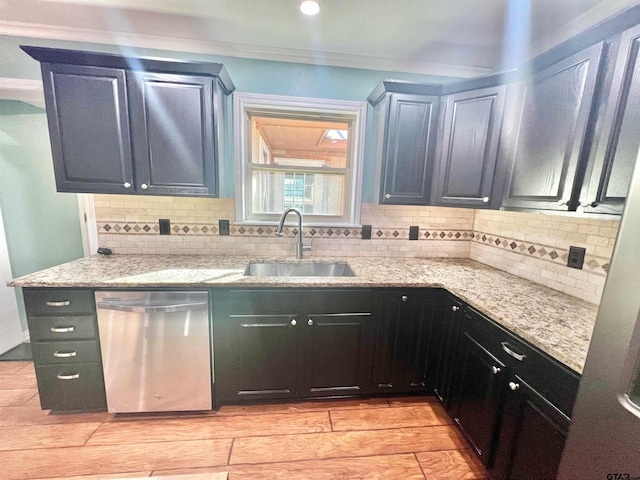 kitchen with dishwasher, decorative backsplash, sink, and light stone counters