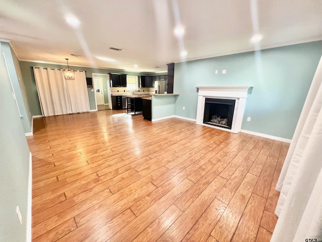 unfurnished living room with light wood-type flooring