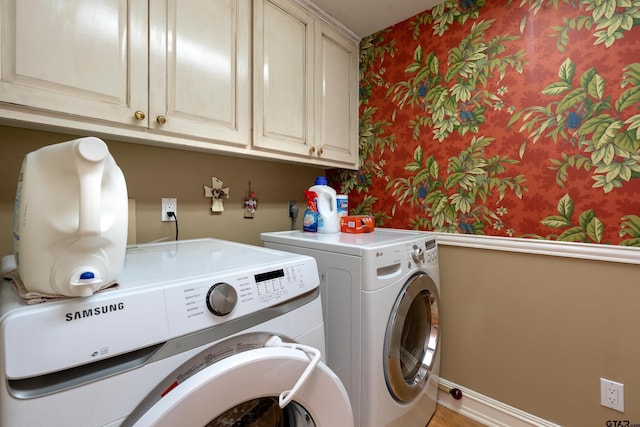 1014 Lovers Ln, Longview, TX 75604 - clothes washing area with independent washer and dryer, cabinet space, and wallpapered walls
