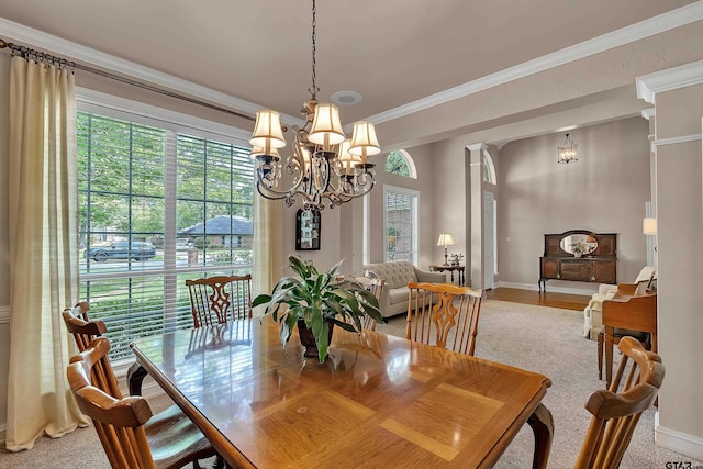 1014 Lovers Ln, Longview, TX 75604 - dining area with a chandelier, baseboards, ornamental molding, and light colored carpet