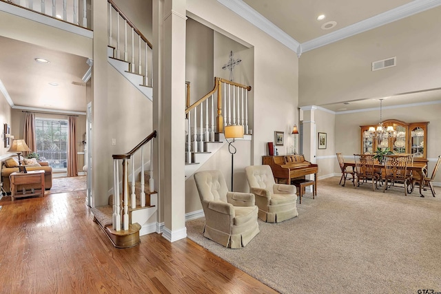 1014 Lovers Ln, Longview, TX 75604 - living area with a towering ceiling, stairs, ornamental molding, baseboards, and a chandelier