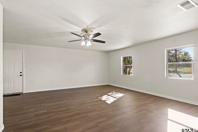 unfurnished room with ceiling fan, a healthy amount of sunlight, and dark hardwood / wood-style floors