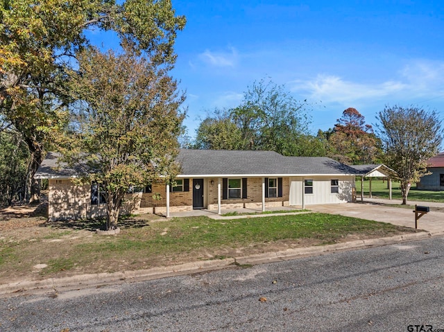 view of front facade with a front lawn and a carport