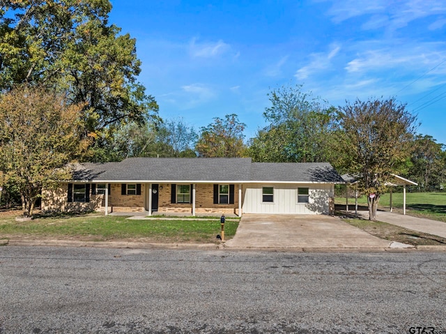 ranch-style house featuring a carport and a front lawn