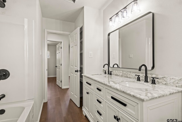 bathroom featuring shower / tub combination, vanity, and hardwood / wood-style flooring