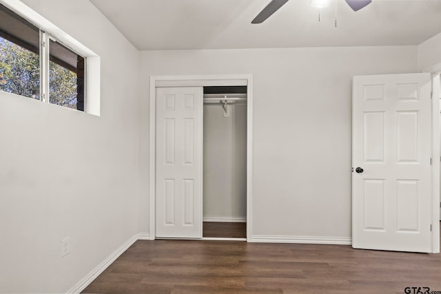 unfurnished bedroom featuring ceiling fan, a closet, and dark hardwood / wood-style floors