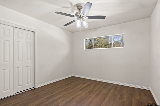 unfurnished bedroom featuring a closet, ceiling fan, and dark wood-type flooring