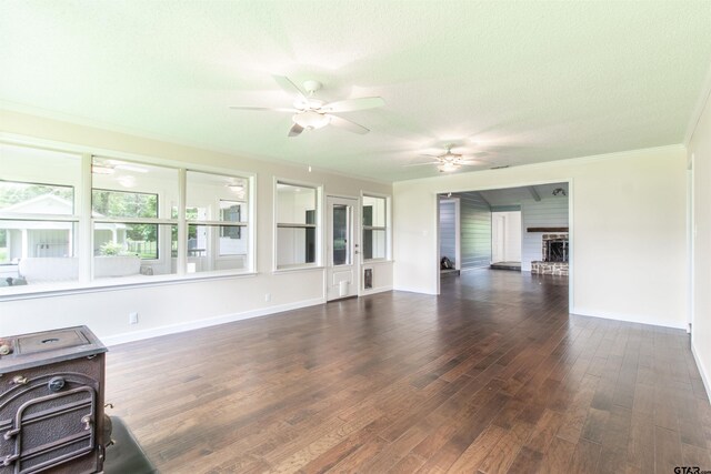 17893 Slack Rd, Whitehouse, TX 75791 - unfurnished living room featuring a ceiling fan, ornamental molding, wood finished floors, a brick fireplace, and a textured ceiling