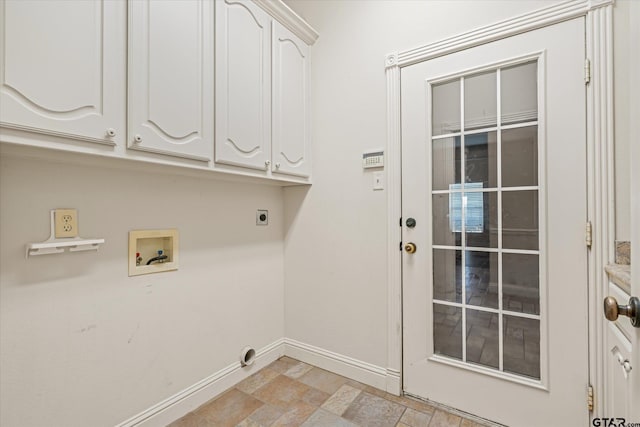 laundry room featuring stone finish floor, baseboards, electric dryer hookup, cabinet space, and washer hookup