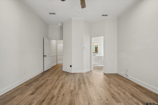 unfurnished bedroom featuring light wood-type flooring, visible vents, crown molding, and baseboards
