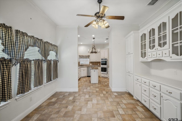 kitchen featuring stone finish floor, double oven, dishwasher, and baseboards
