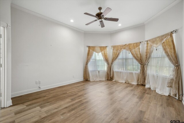 unfurnished room with a ceiling fan, crown molding, wood finished floors, baseboards, and recessed lighting