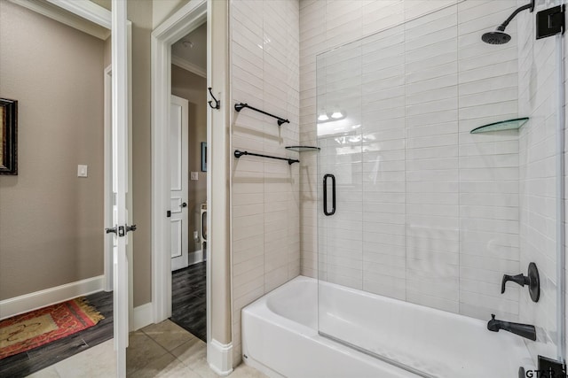 bathroom featuring wood-type flooring, tiled shower / bath, and ornamental molding