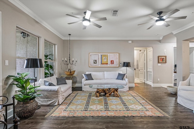 living room with ceiling fan with notable chandelier, dark hardwood / wood-style flooring, and ornamental molding