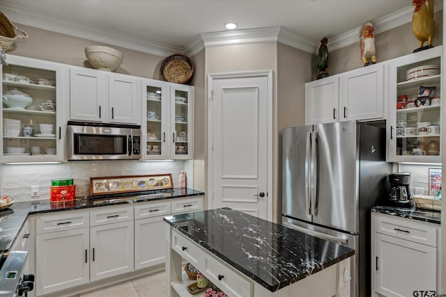 kitchen with white cabinetry, backsplash, and appliances with stainless steel finishes