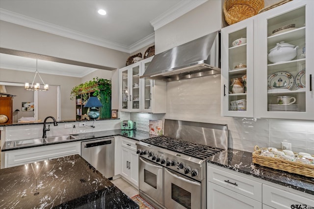 kitchen featuring white cabinets, wall chimney exhaust hood, dark stone counters, and appliances with stainless steel finishes