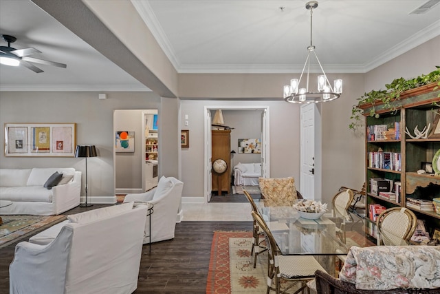 dining area with dark hardwood / wood-style floors, crown molding, and ceiling fan with notable chandelier