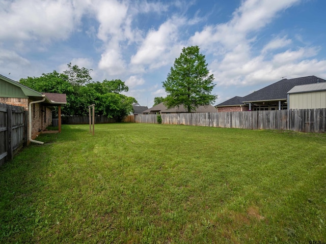 view of yard with a fenced backyard