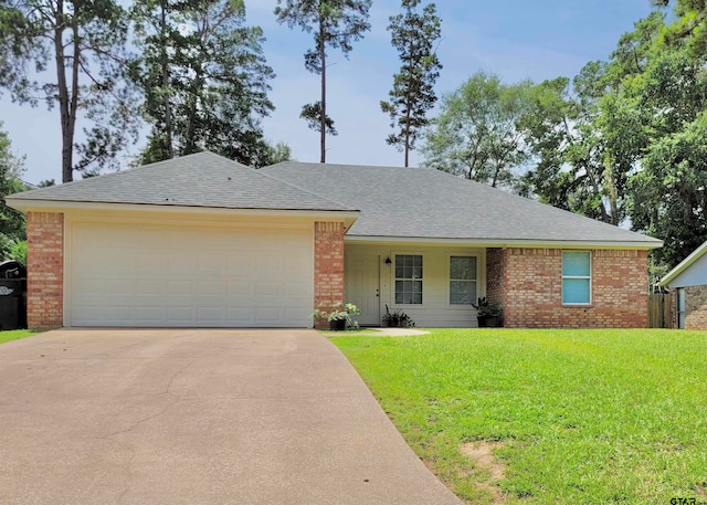 single story home with a garage and a front lawn