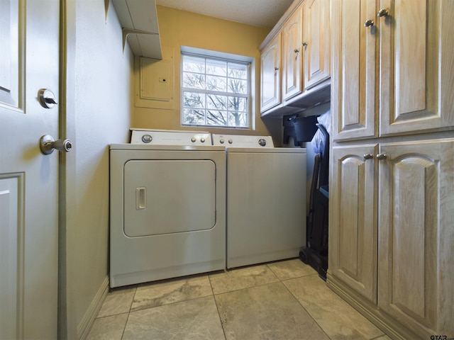 clothes washing area featuring cabinets, independent washer and dryer, electric panel, and light tile patterned flooring