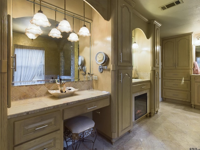 bathroom with vanity and tasteful backsplash