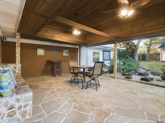 exterior space featuring ceiling fan, beamed ceiling, and wooden ceiling