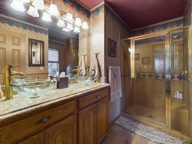 bathroom with vanity, hardwood / wood-style flooring, and an enclosed shower