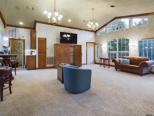 living room with light carpet, high vaulted ceiling, an inviting chandelier, and crown molding