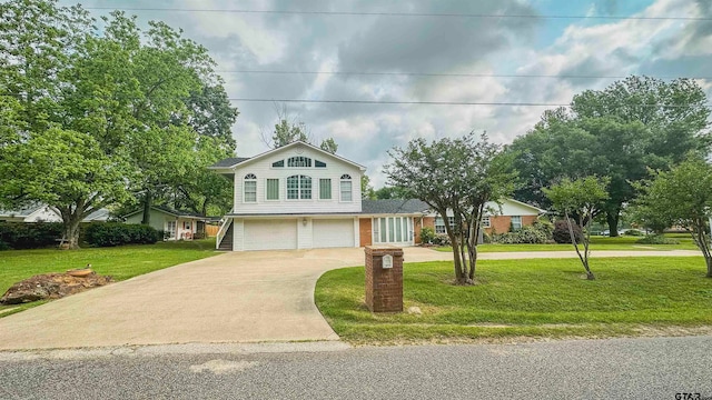 view of front of house with a garage and a front yard