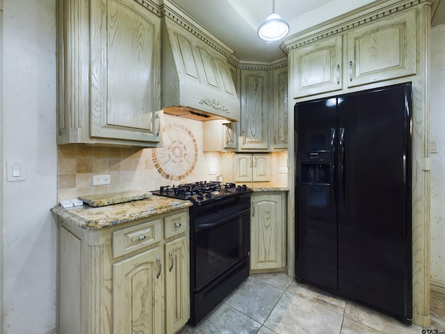 kitchen featuring light stone countertops, tasteful backsplash, light tile patterned floors, black appliances, and custom exhaust hood