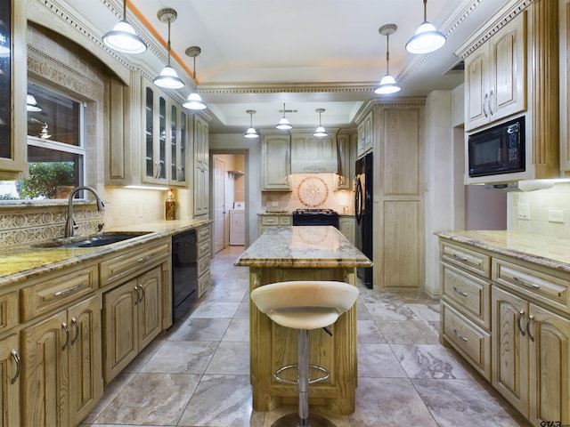 kitchen with sink, tasteful backsplash, a tray ceiling, a kitchen island, and black appliances