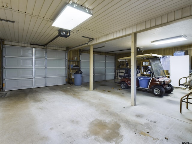 garage featuring a garage door opener and a carport