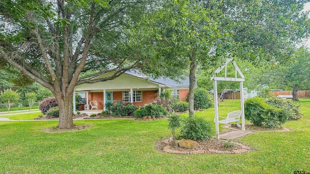 view of front of property with covered porch and a front lawn