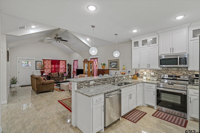 kitchen with stainless steel appliances, white cabinets, sink, and lofted ceiling with beams