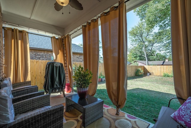 sunroom / solarium featuring ceiling fan