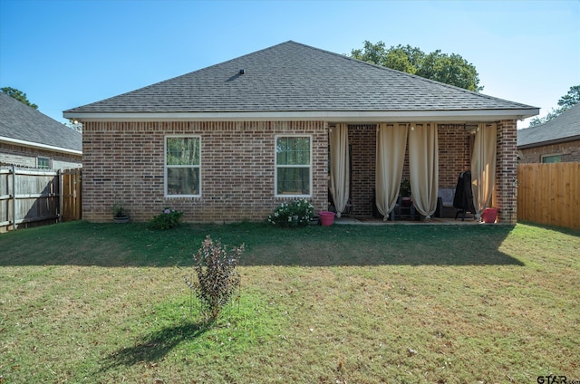 rear view of property with a lawn