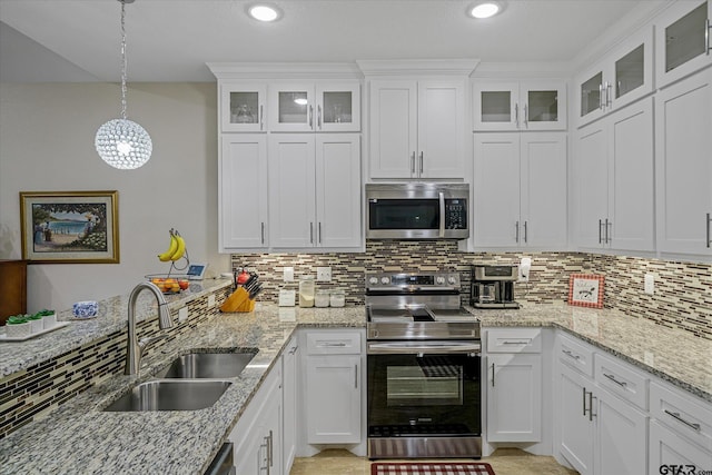 kitchen with white cabinetry, hanging light fixtures, sink, and stainless steel appliances