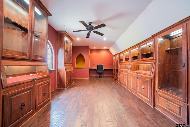 unfurnished office with ceiling fan, dark wood-style floors, and lofted ceiling