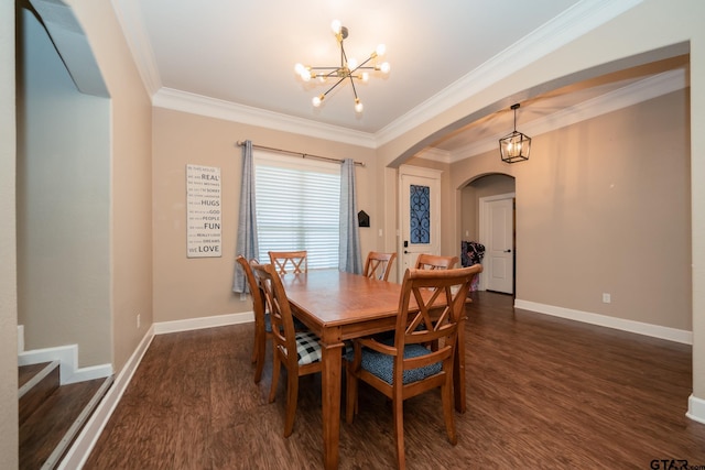 dining area with dark wood-type flooring, arched walkways, crown molding, and an inviting chandelier