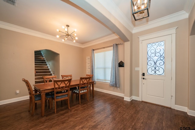 dining space with arched walkways, ornamental molding, dark wood-style flooring, and an inviting chandelier