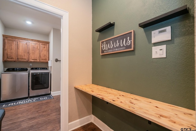 laundry area with cabinet space, baseboards, separate washer and dryer, and dark wood-style flooring