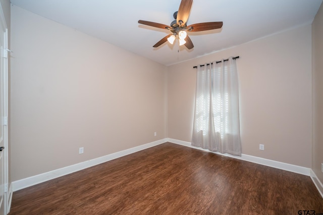 unfurnished room with dark wood-type flooring, baseboards, and a ceiling fan