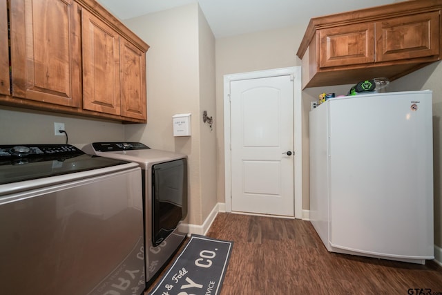 laundry room with washing machine and dryer, dark wood-style flooring, cabinet space, and baseboards