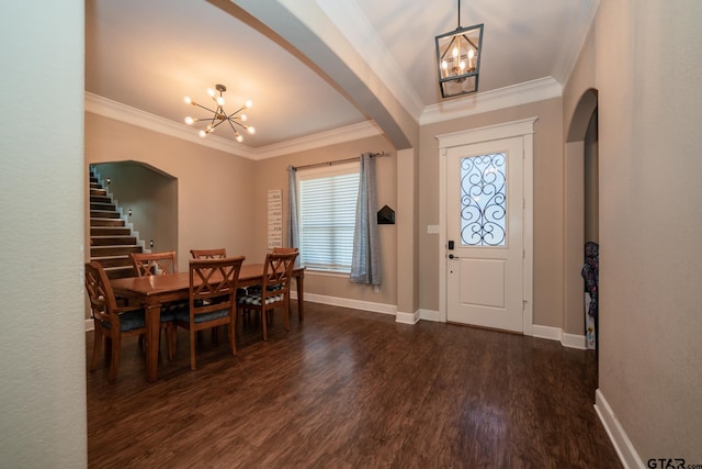 foyer with an inviting chandelier, arched walkways, dark wood finished floors, and ornamental molding