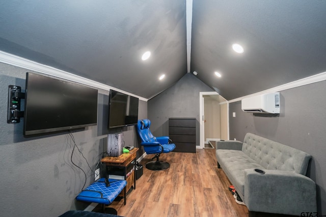 cinema room with vaulted ceiling, wood finished floors, and a wall mounted air conditioner