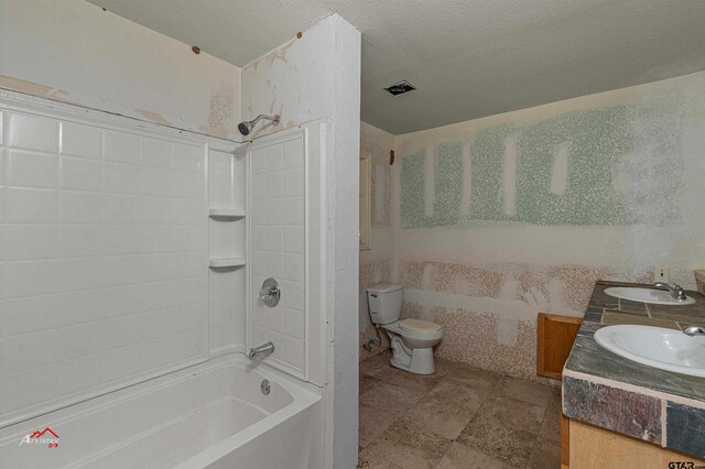 full bathroom with toilet, vanity, a textured ceiling, and  shower combination