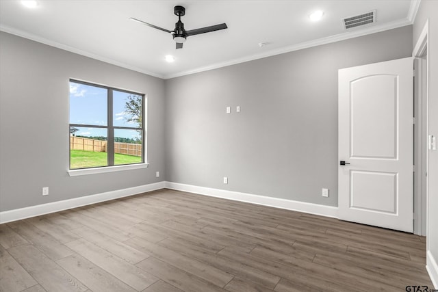 empty room with hardwood / wood-style flooring, ceiling fan, and crown molding