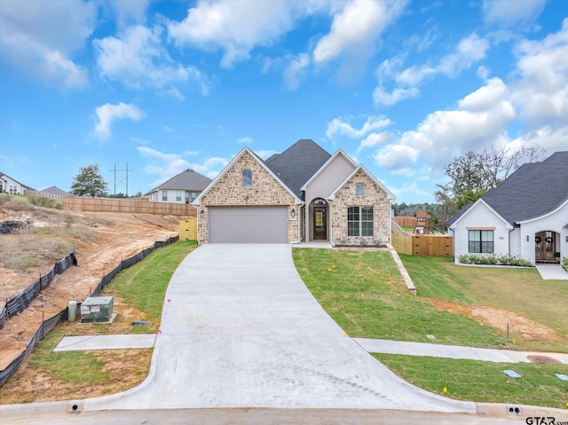 view of front of home featuring a front yard and a garage