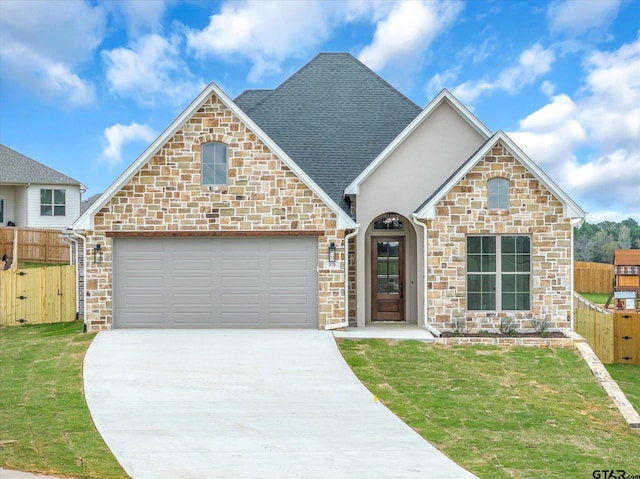 view of front property with a garage and a front lawn