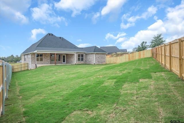 rear view of house with a lawn